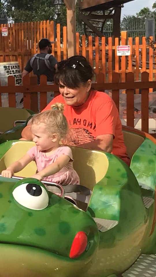 Shon rides with her grandchild on a "kiddie ride."