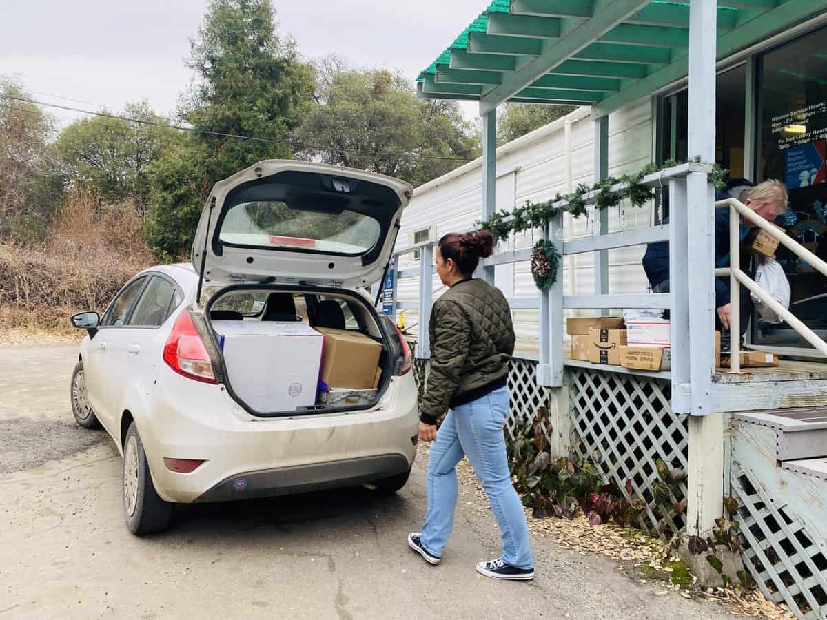 Angela's compact car, loaded with US Post Office packages.