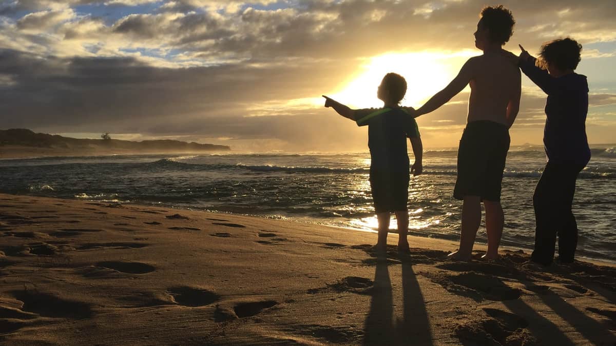 Amanda Rose and sons on a Kauai beach at sunset