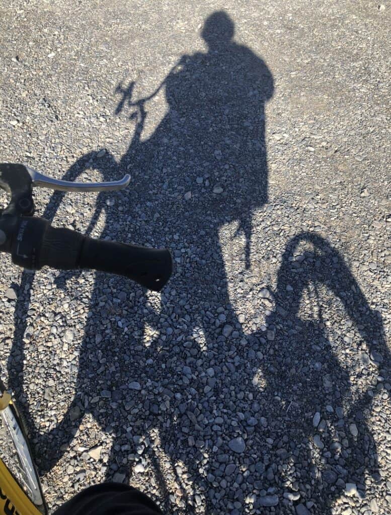 A photo of the shadow of Faith on her tricycle.