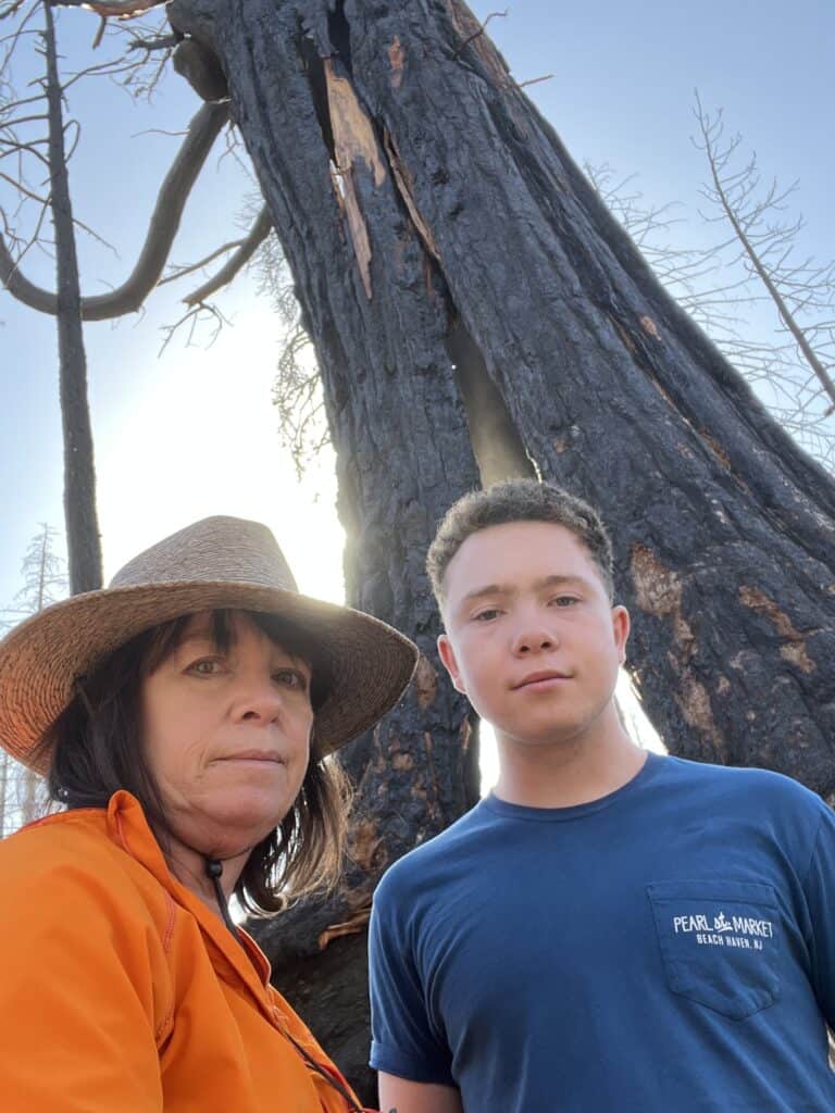 Amanda and Frederick in front of a dead giant sequoia