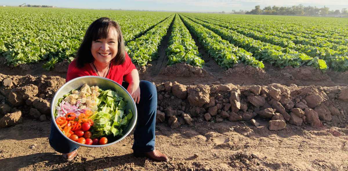 Amanda Rose in a field of romaine with a Ridiculously Big Salad