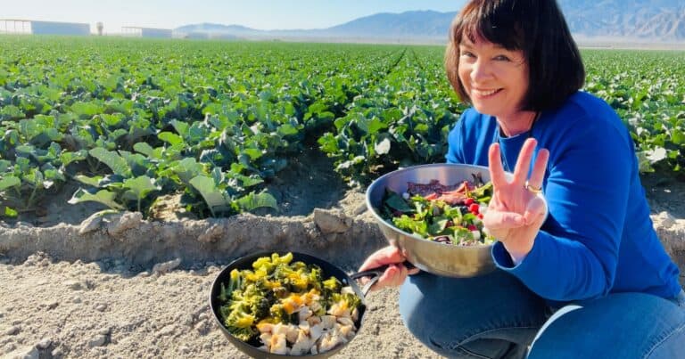 Amanda Rose in a vegetable field with two dishes from the Three-Day Challenge