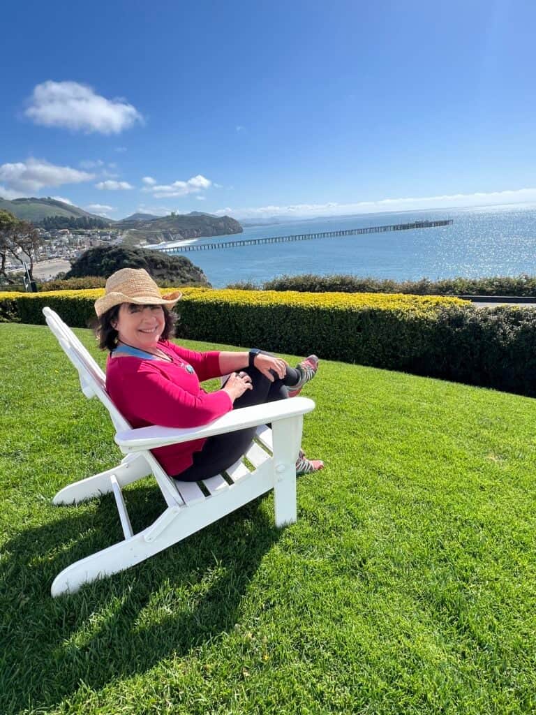 Amanda Rose sitting in a lawn chair near the beach